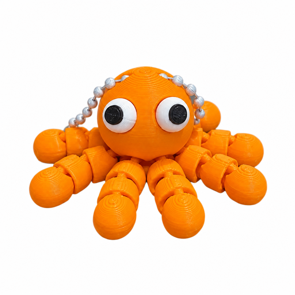 3D printed orange octopus keychain side view on white background