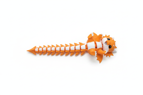 3D printed articulated dragon fidget toy in orange and white, fully extended on a white background