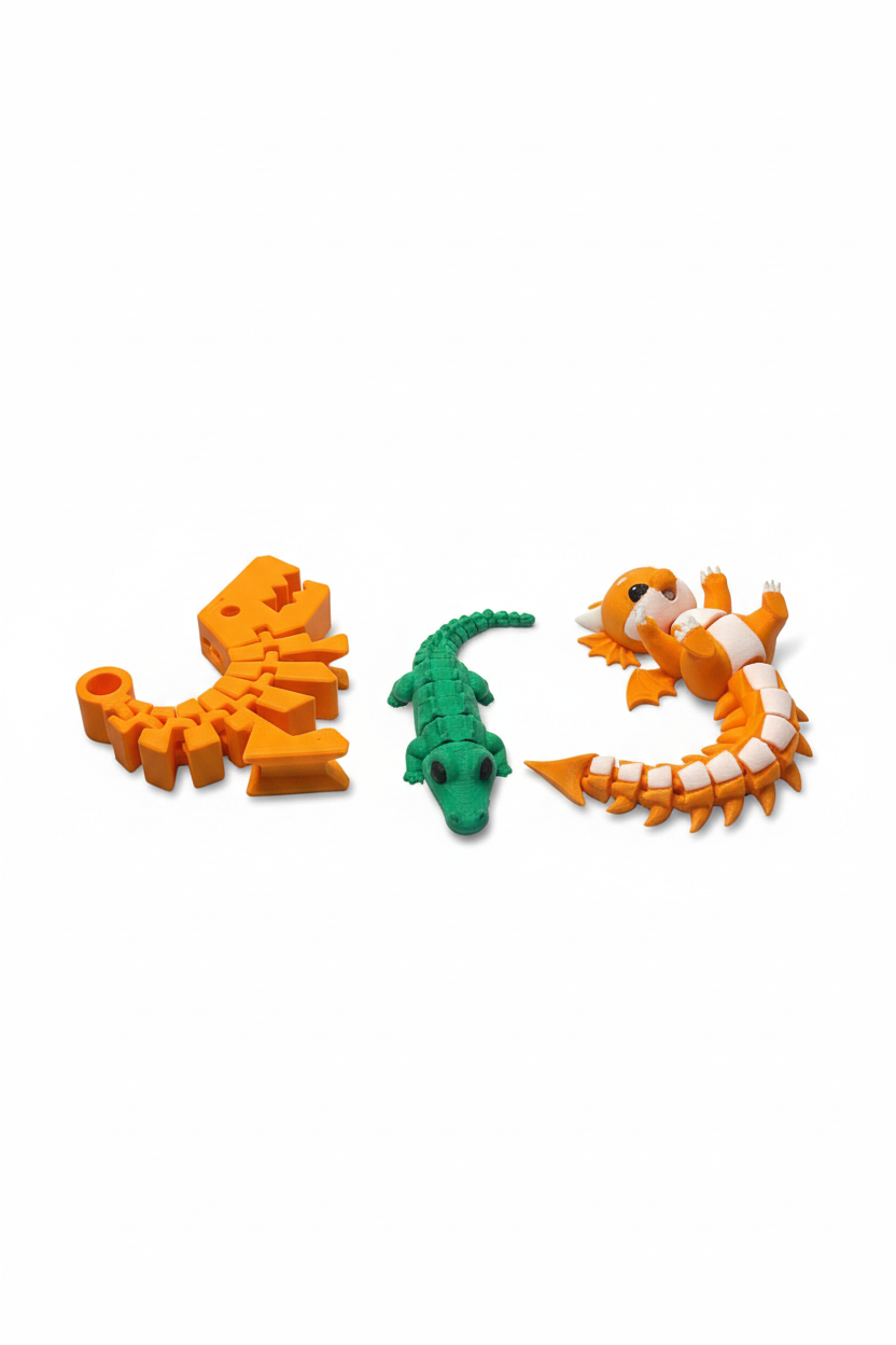 Top view of an articulated dinosaur skeleton, alligator, and dragon three-piece toy bundle on white