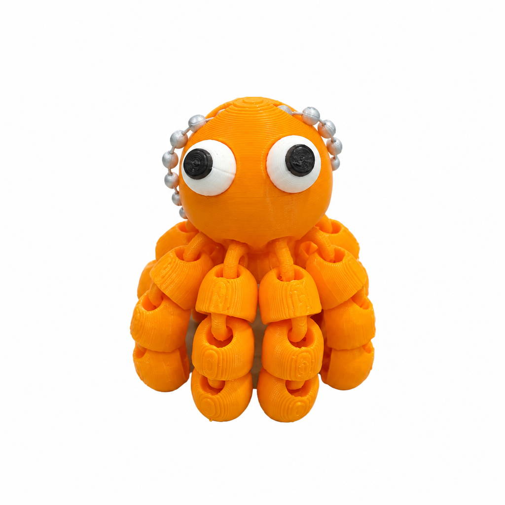 3D printed orange octopus keychain on white background