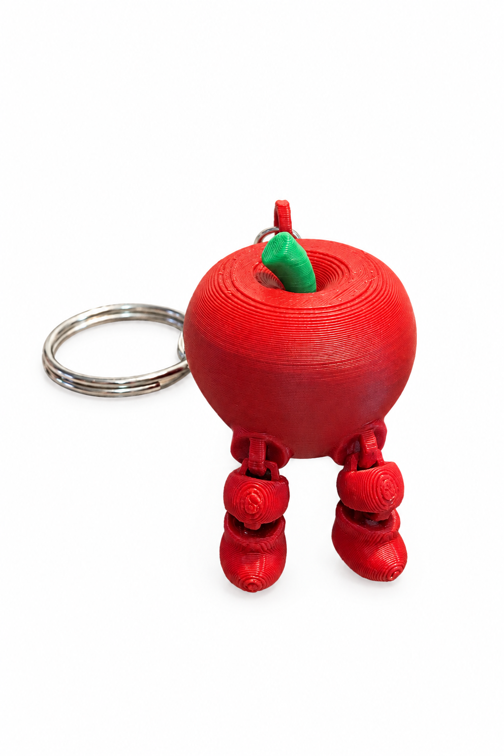 Red apple keychain showing dangling articulated legs on a white background