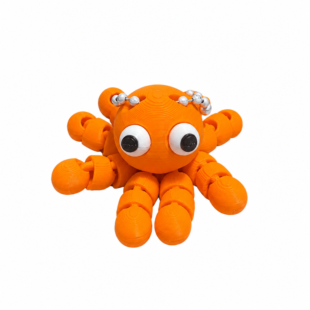 3D printed orange octopus keychain detail on white background