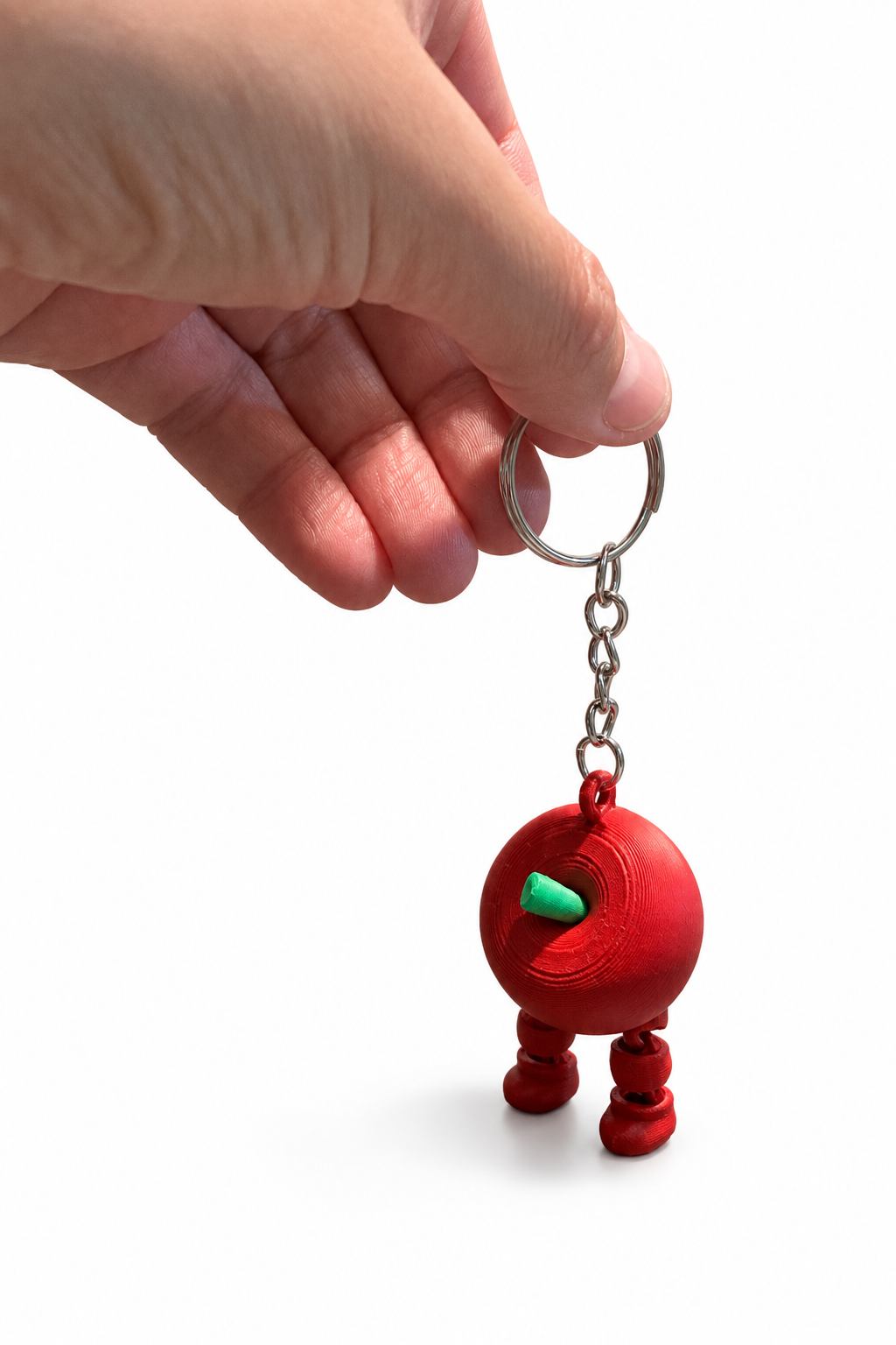 Apple keychain held by its metal keyring against a white background