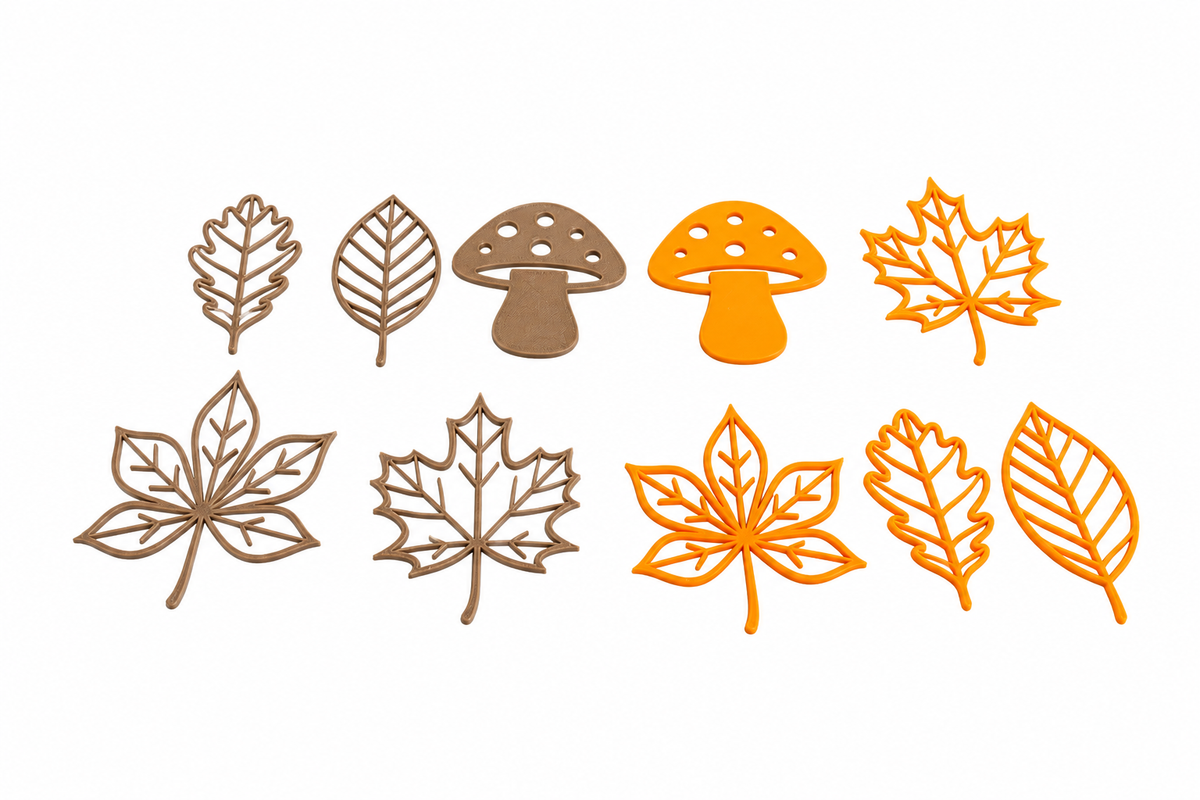 Set of 10 3D printed autumn leaves and mushrooms in brown and orange on a white background